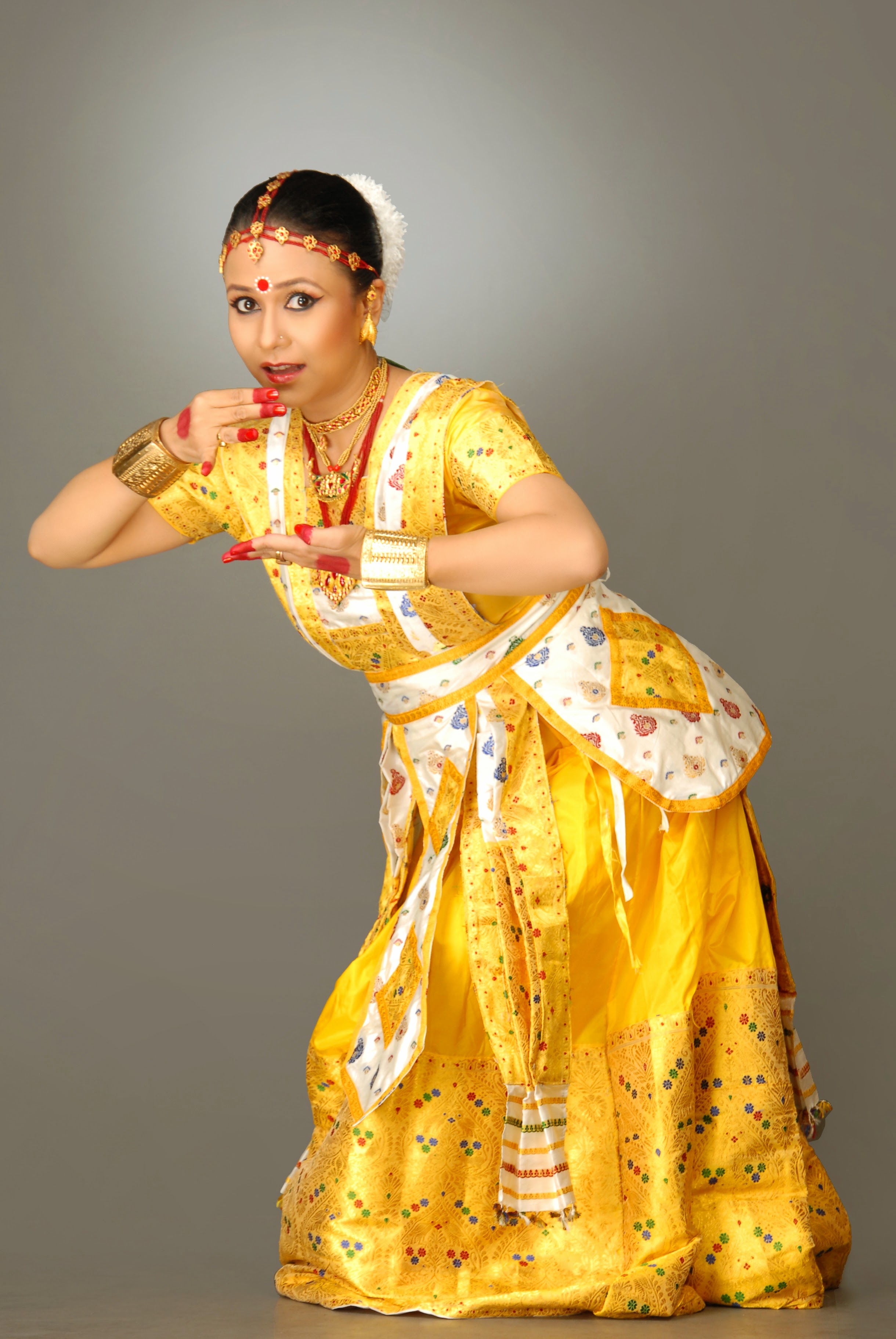 Madhusmita striking a pose of krishna stealing butter